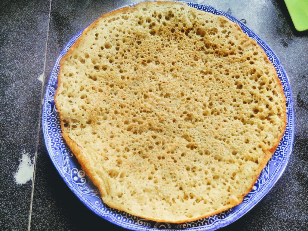 sourdough pikelet on a blue plate