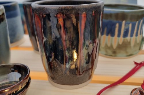 ceramic beaker and mugs and christmas decoration on wooden crate